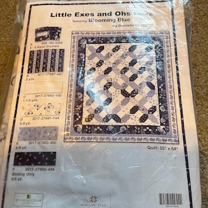 May include: A quilt kit in a plastic package. The kit is titled "Little Exes and Ohs" featuring "Blooming Blue" by Danielle Leone. The quilt design is a blue and white pattern. The quilt measures 55 inches by 64 inches.