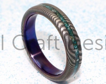 Stainless Damascus ring inlaid with coloured Ashes and purple titanium sleeve.Cremation memorial custom wedding bands handmade in Scotland