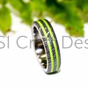 Damascus ring with painted lime green grooves. Custom wedding band handmade to order from Scotland UK