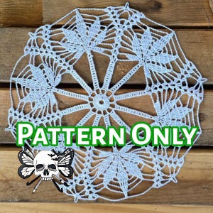 May include: A white crochet doily with a delicate floral pattern. The doily is circular and has a center with a starburst design. The text "PATTERN ONLY" is superimposed on the doily.