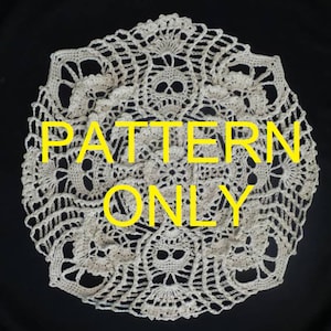 May include: A white crochet doily with a skull pattern. The doily is round and has a delicate lace design. The text "PATTERN ONLY" is superimposed on the image.