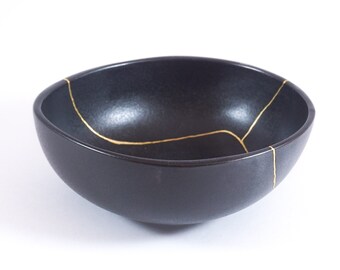 Black Kintsugi bowl restored with the traditional method. Celebratory gift for overcoming a difficult period or an illness.
