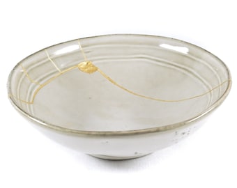 Kintsugi bowl, Restored beige contemporary ceramic, perfect as a gift for overcoming a trauma or good healing.