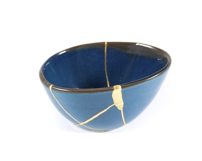 Kintsugi bowl with real gold finish. Contemporary blue ceramic repaired with the authentic Japanese technique of restoration with gold.