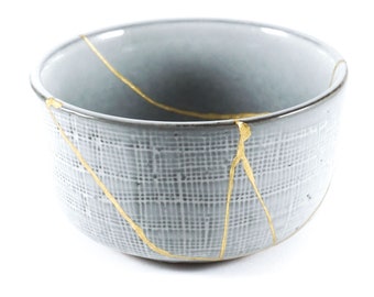 kintsugi, Japanese gold restoration bowl, gray wabi sabi bowl with relief decoration, contemporary ceramic restored in real gold