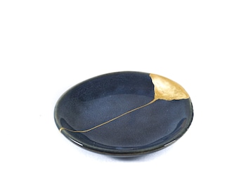 Kintsugi contemporary saucer, Japanese restoration in real gold, small restored wabi sabi ceramic with gold scars.