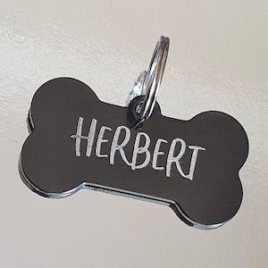 Dog ID tags, black bones with silver showing through, various fonts to choose from