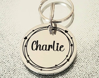 Beautiful stylish pet ID tag, with 'heart strings' border design. Available in silver, gold, rose gold or black stainless Steel