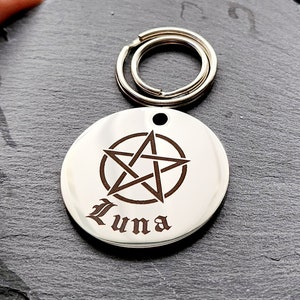 May include: Silver round keychain with a pentagram engraved on it. The name "Luna" is engraved below the pentagram.