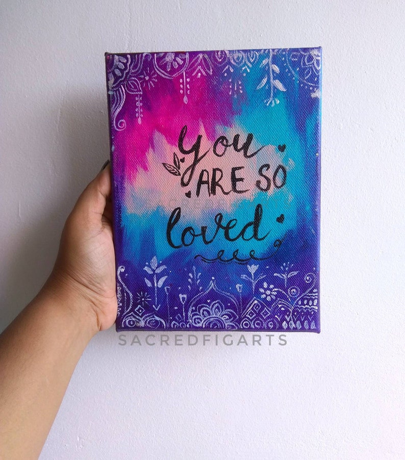 May include: A hand-painted canvas with a colorful background and white mandala designs. The canvas features the text "You are so loved" in black calligraphy.