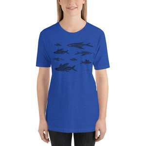 May include: A royal blue t-shirt with a black and white illustration of a school of flying fish.