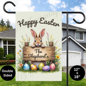 May include: A double-sided garden flag with a light green background. The flag features a cartoon bunny rabbit holding a wooden sign that reads "The Shepherd's". The bunny is surrounded by colorful Easter eggs and flowers. The text "Happy Easter" is printed in brown at the top of the flag. The flag measures 12 inches by 18 inches.