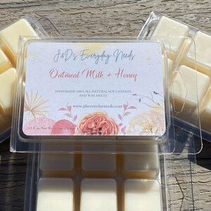May include: A clear plastic container with nine individual wax melts. The wax melts are a light yellow color. The container has a label that reads "J&D's Everyday Needs Oatmeal Milk + Honey Handmade 100% All Natural Soy Candles and Wax Melts www.jdseverydayneeds.com 3.1 fl. oz./Net Wt. 2.7 oz. (76.5 g)"