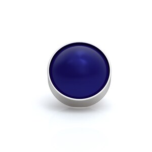 May include: A circular cabochon with a smooth, deep blue surface set within a simple, polished silver-toned metal bezel. The object features a domed top that reflects light, creating a subtle highlight on its glossy, solid-colored surface.