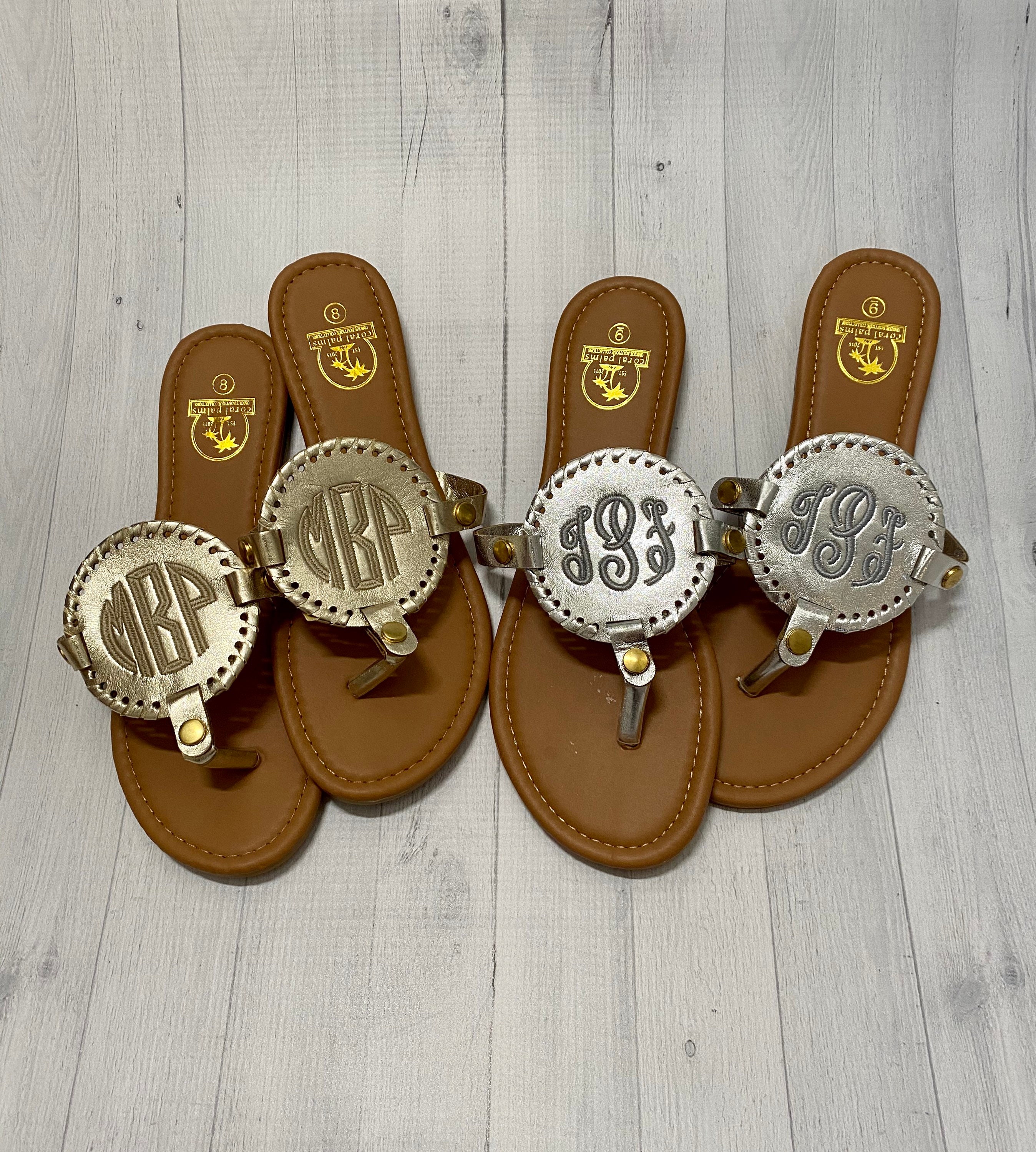 flip flops with gold medallion