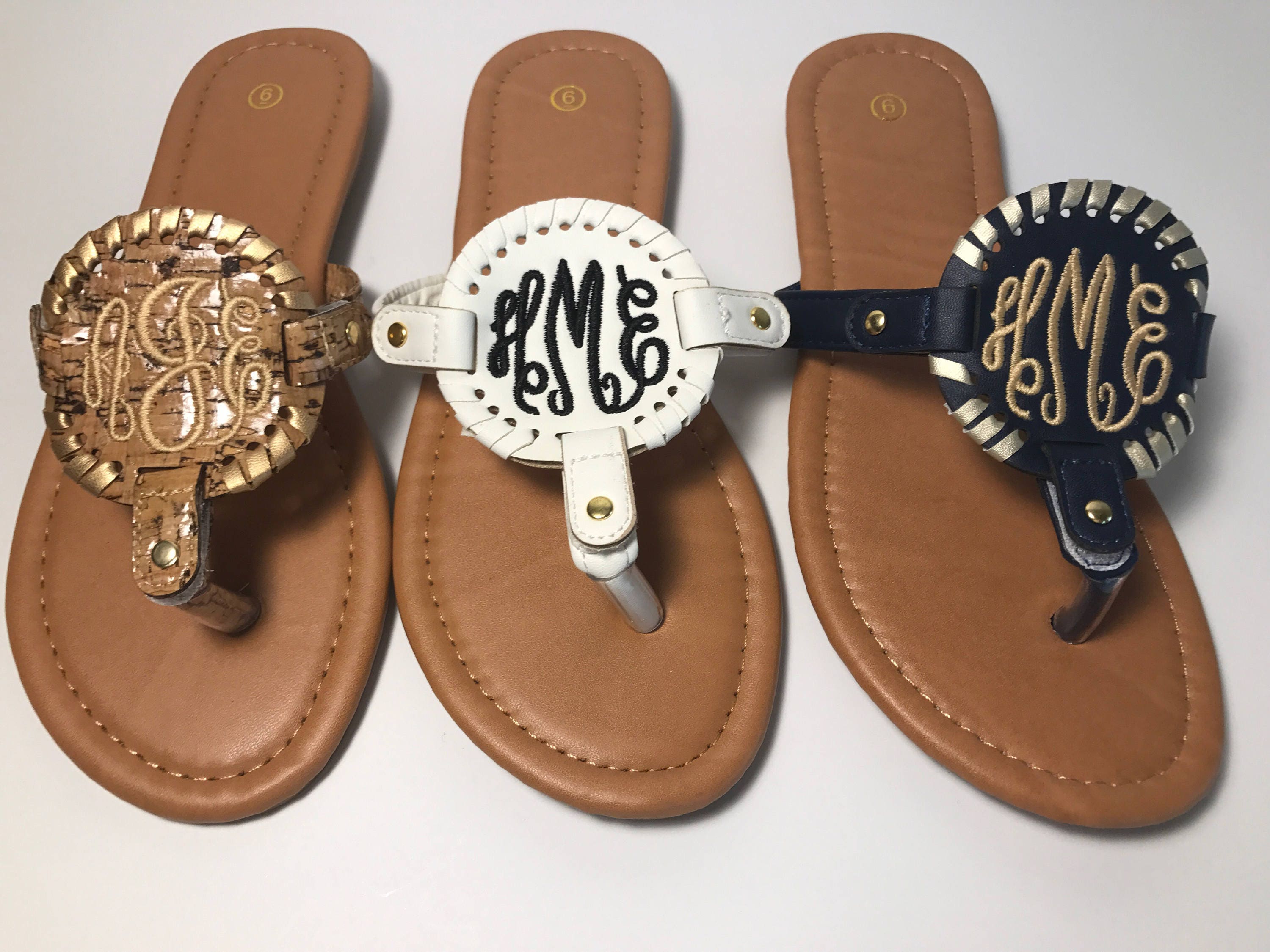flip flops with gold medallion