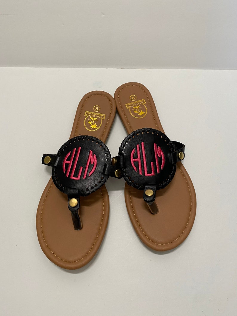 flip flops with gold medallion