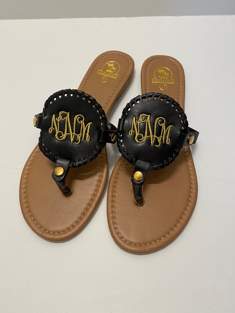 flip flops with gold medallion