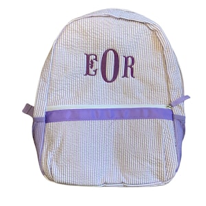 May include: A purple and white striped backpack with a purple zipper and a purple embroidered monogram "EOR".
