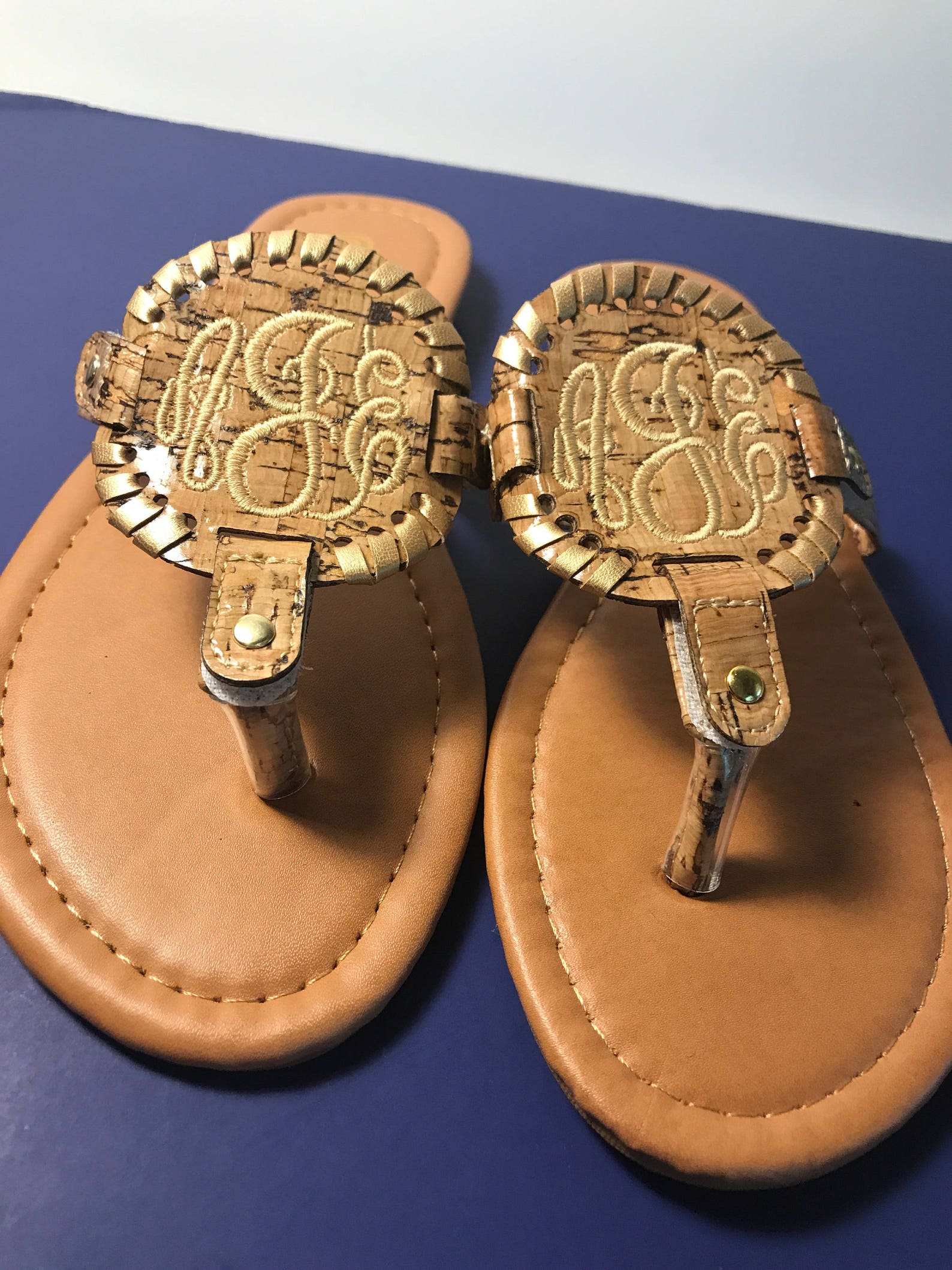 flip flops with gold medallion