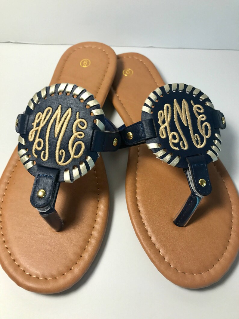 flip flops with gold medallion