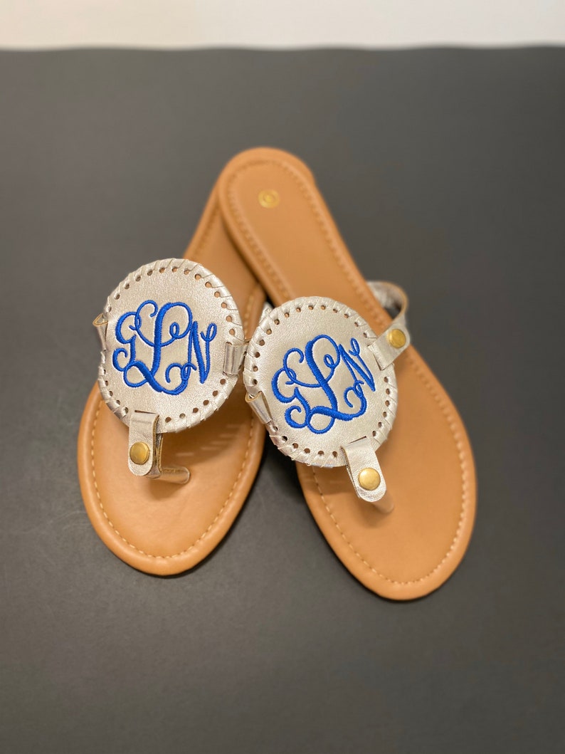 flip flops with gold medallion