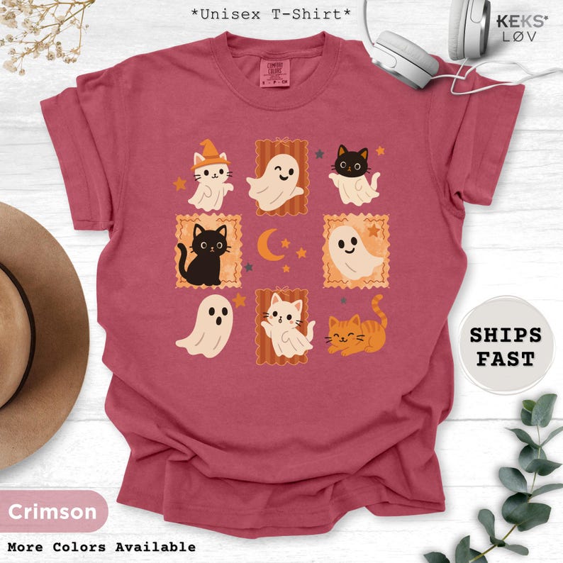 unisex t-shirt with retro Halloween design featuring cute black cats, orange cats, and friendly ghosts in vintage postcard style