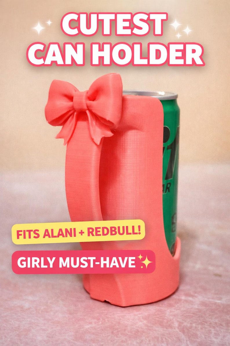 May include: A coral-colored can holder with a bow detail and handle, holding a green can. Text on the holder reads "CUTEST CAN HOLDER", "FITS ALANI + REDBULL!", and "GIRLY MUST-HAVE".