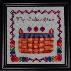 May include: Cross-stitch artwork in a black frame. The design features a woven basket with the words "My Collection" above it. The border is decorated with colorful circles and a zig-zag pattern in red and blue.