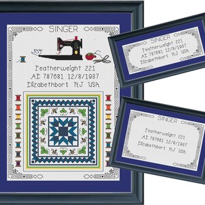May include: Framed cross-stitch artwork featuring a sewing machine, spools of thread, and a quilt design. The artwork includes the text "SINGER" and "Featherweight 221" with additional text. The frame is dark blue.