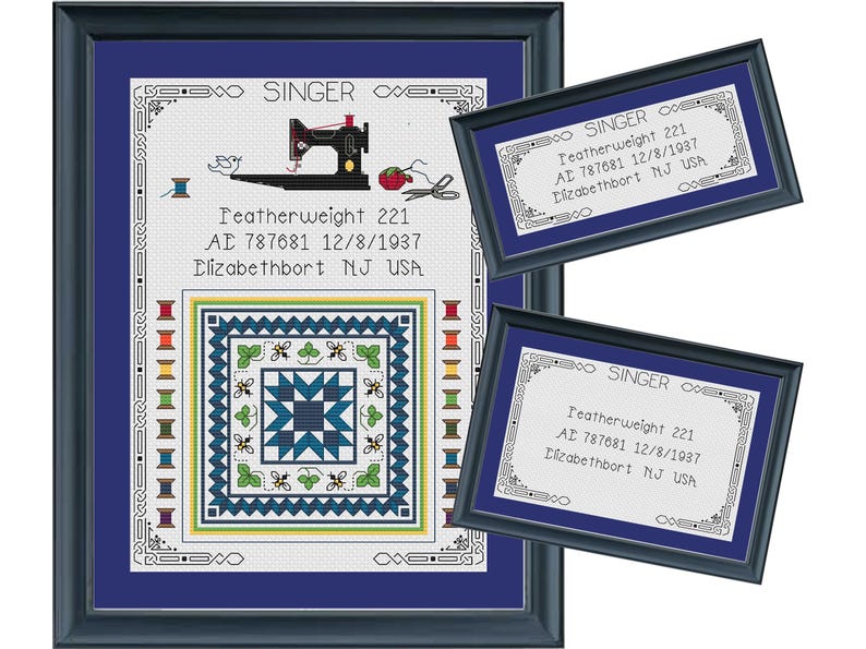 May include: Framed cross-stitch artwork featuring a sewing machine, spools of thread, and a quilt design. The artwork includes the text "SINGER" and "Featherweight 221" with additional text. The frame is dark blue.