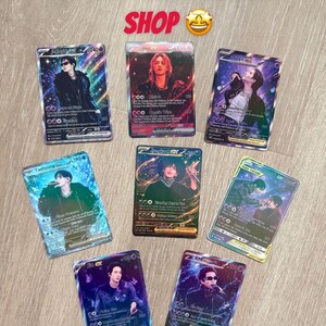 May include: Seven rectangular trading cards featuring individual and group portraits of performers with holographic, starry backgrounds. Each card displays text, numerical values, and game-like statistics. The top of the image includes the text COLLECT THEM ALL IN MY SHOP.