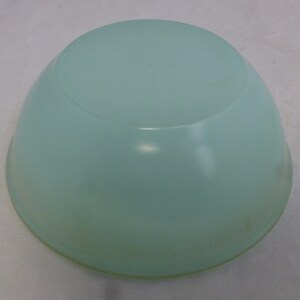 May include: A light blue ceramic bowl with a smooth, rounded surface.