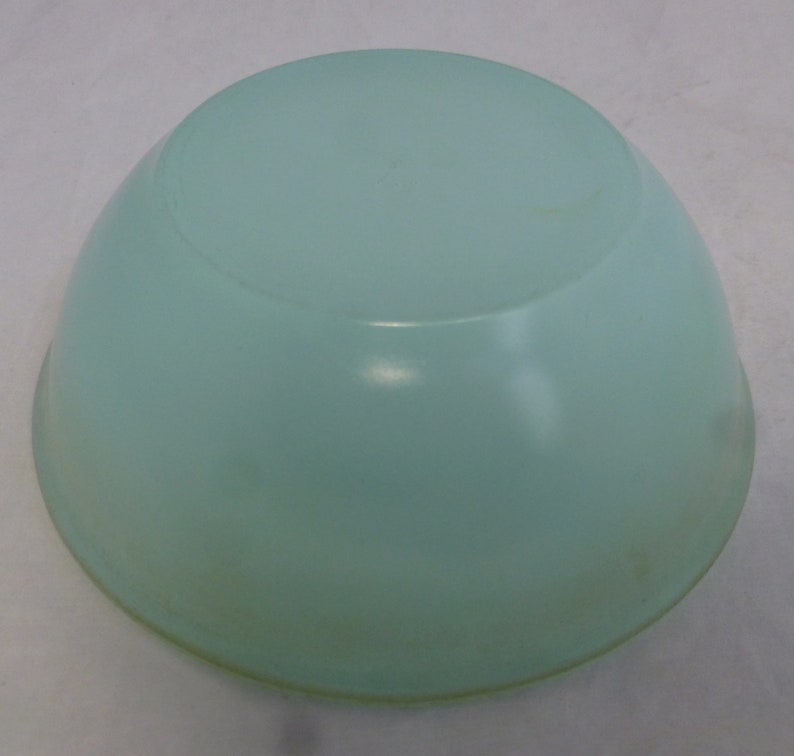 May include: A light blue ceramic bowl with a smooth, rounded surface.