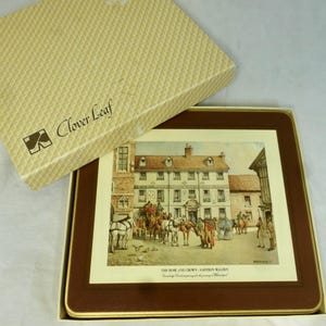 May include: A brown and cream colored coaster with a picture of a building and people in front of it. The text on the coaster reads "The Rose and Crown - Saffron Walden.  Cambridge Road preparing for the arrival of the Mailcoach."