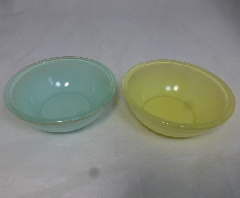 May include: Two plastic mixing bowls, one light blue and one yellow.