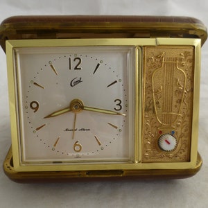 Coral Japanese Vintage Musical Alarm Bedside Travel Clock - Gold Tone Bird Panel & Brown Cover - Wind Up Analogue - Crack in case  A/F