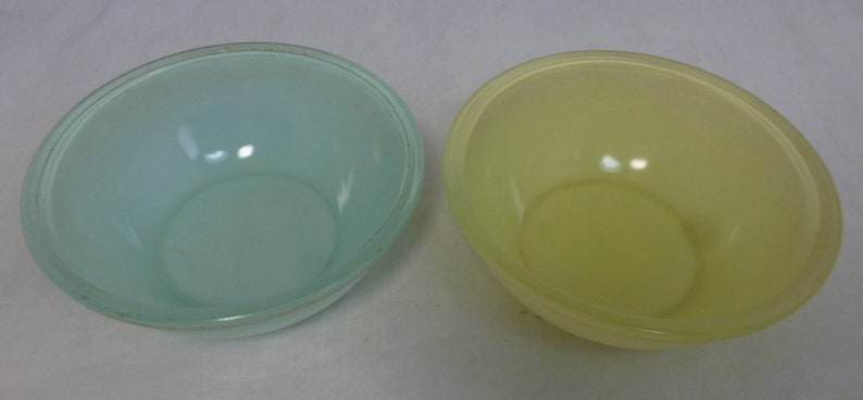 May include: Two empty bowls, one light blue and one yellow.