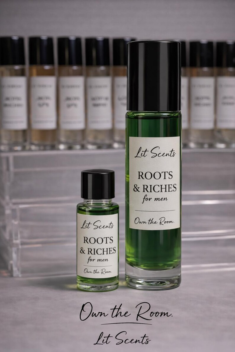 May include: Two glass perfume bottles with black caps. The larger bottle contains green liquid and a label that reads "Lit Scents ROOTS & RICHES for men." The smaller bottle has the same label. The text "Own the Room" is also visible.