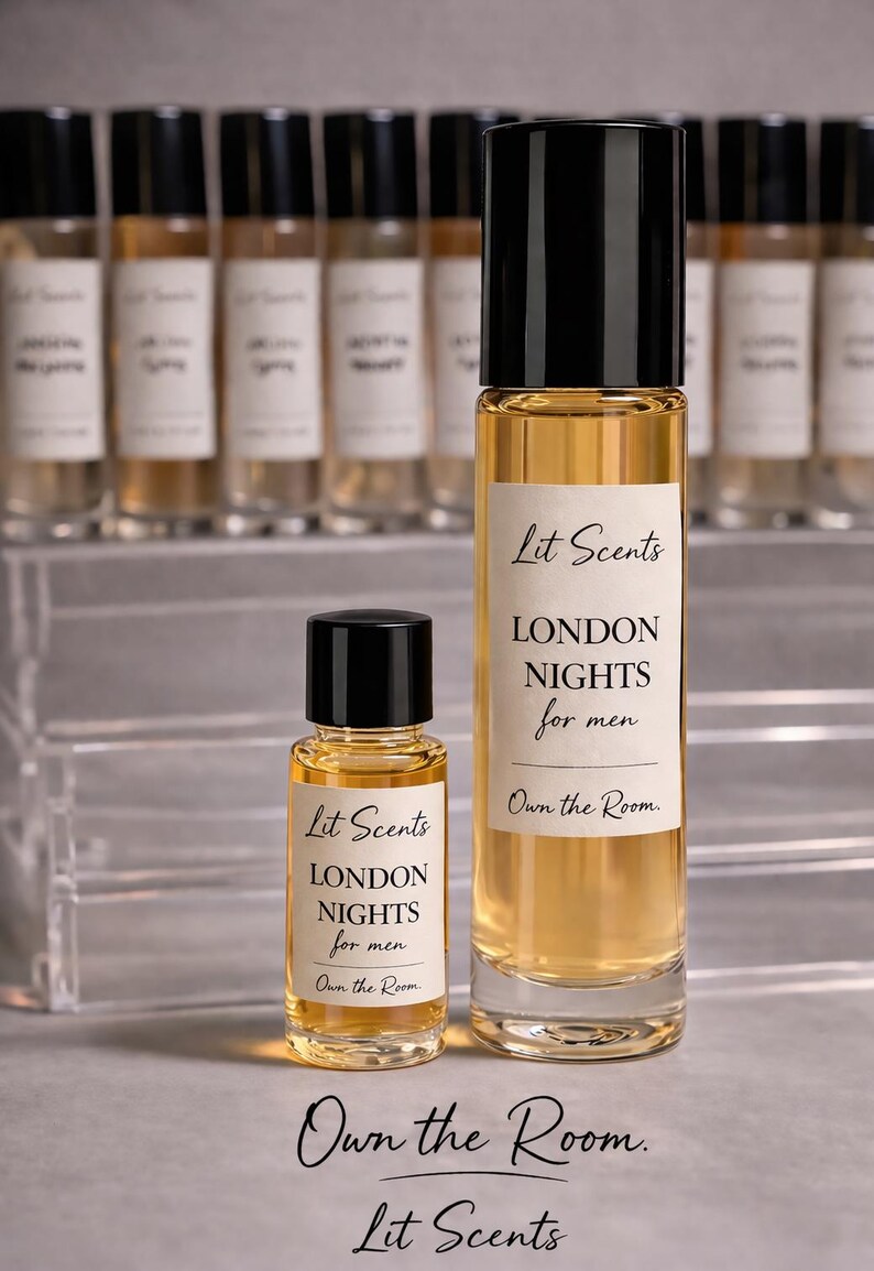 May include: Two glass perfume bottles with black caps, one large and one small, filled with a golden liquid. The labels read "Lit Scents LONDON NIGHTS for men Own the Room." Additional bottles are visible in the background.