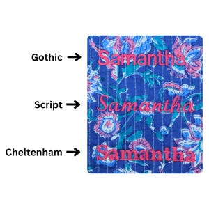 May include: A blue floral patterned fabric with the name "Samantha" embroidered in pink in three different fonts: Gothic, Script, and Cheltenham. The fabric has a quilted appearance.