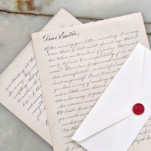 Custom love letter calligraphy on vintage paper with red heart wax seal.