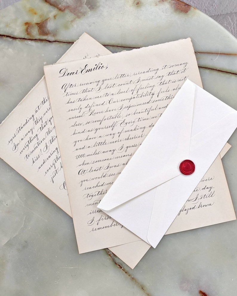 Custom love letter calligraphy on vintage paper with red heart wax seal.