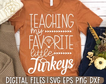 May include: Orange t-shirt with white text that reads "TEACHING my FAVORITE little Turkeys". A small turkey illustration is included in the text. The text "DIGITAL FILES | SVG EPS PNG DXF" is at the bottom of the shirt.