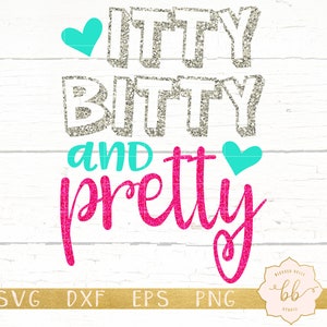May include: A silver glitter design with the text "itty bitty and pretty" in pink glitter with turquoise hearts on a white wood background.