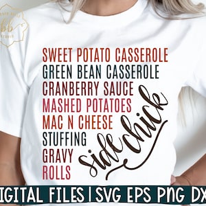 May include: White t-shirt with a brown and white design that says "Side Chick" with a list of Thanksgiving side dishes: Sweet Potato Casserole, Green Bean Casserole, Cranberry Sauce, Mashed Potatoes, Mac N Cheese, Stuffing, Gravy, Rolls.