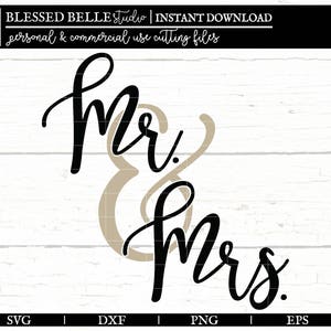 May include: Black and white calligraphy text that reads "Mr. & Mrs." on a white wood background.