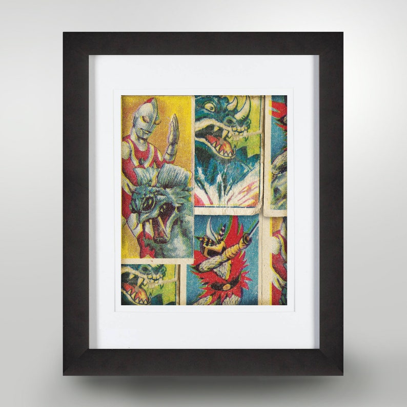 May include: A framed collage of vintage trading cards featuring colourful illustrations of monsters and superheroes. The cards are arranged in a random pattern and include text like "Ultraman" and "Kaiju".