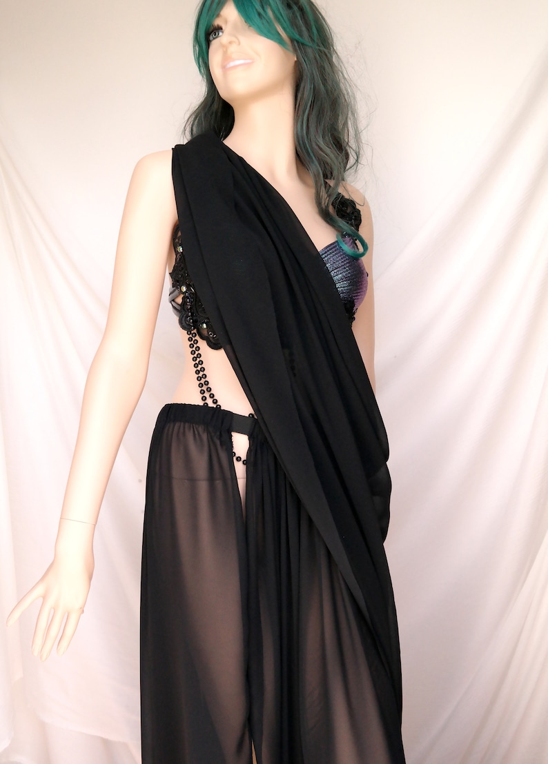 May include: A black sheer maxi skirt with a black beaded chain detail and a black sheer top with a beaded embellishment.