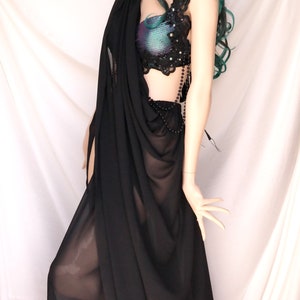 May include: A black sheer saree with a beaded and lace top. The top has a iridescent fabric with black lace and beads.